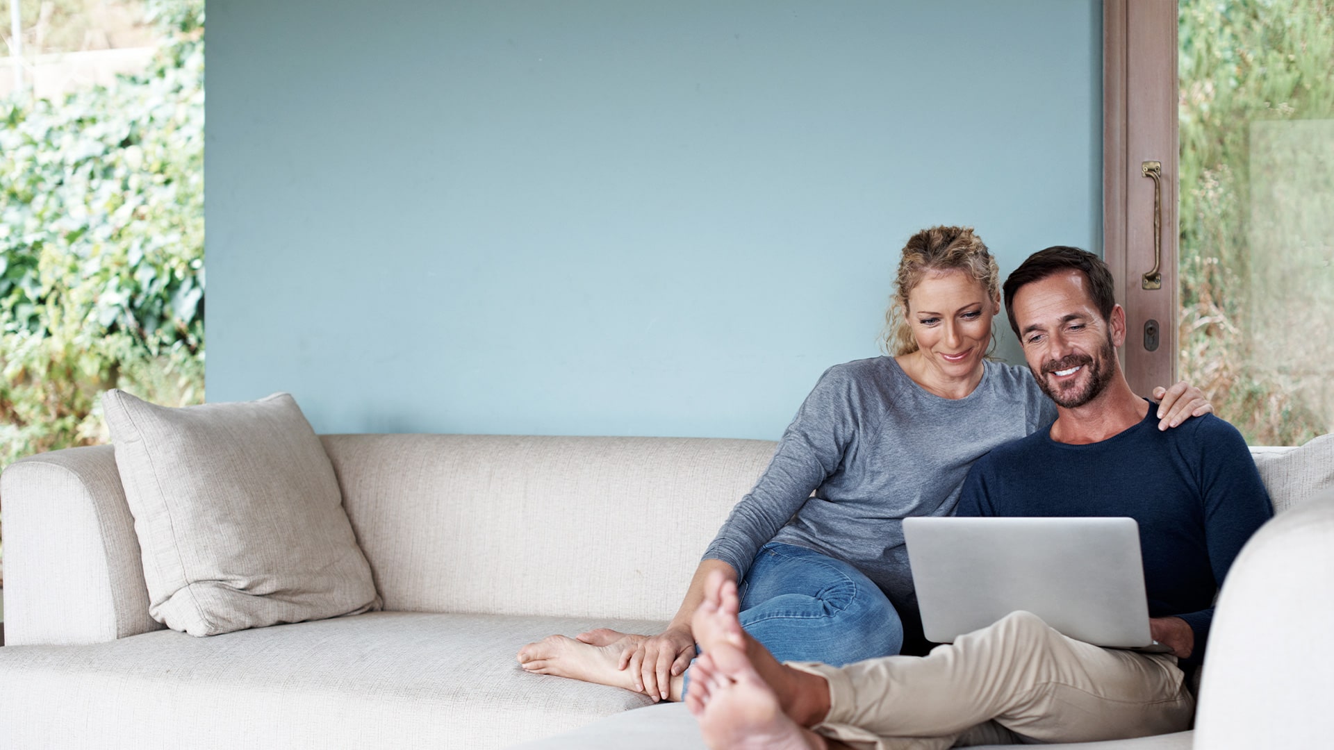 couple on couch looking for homes